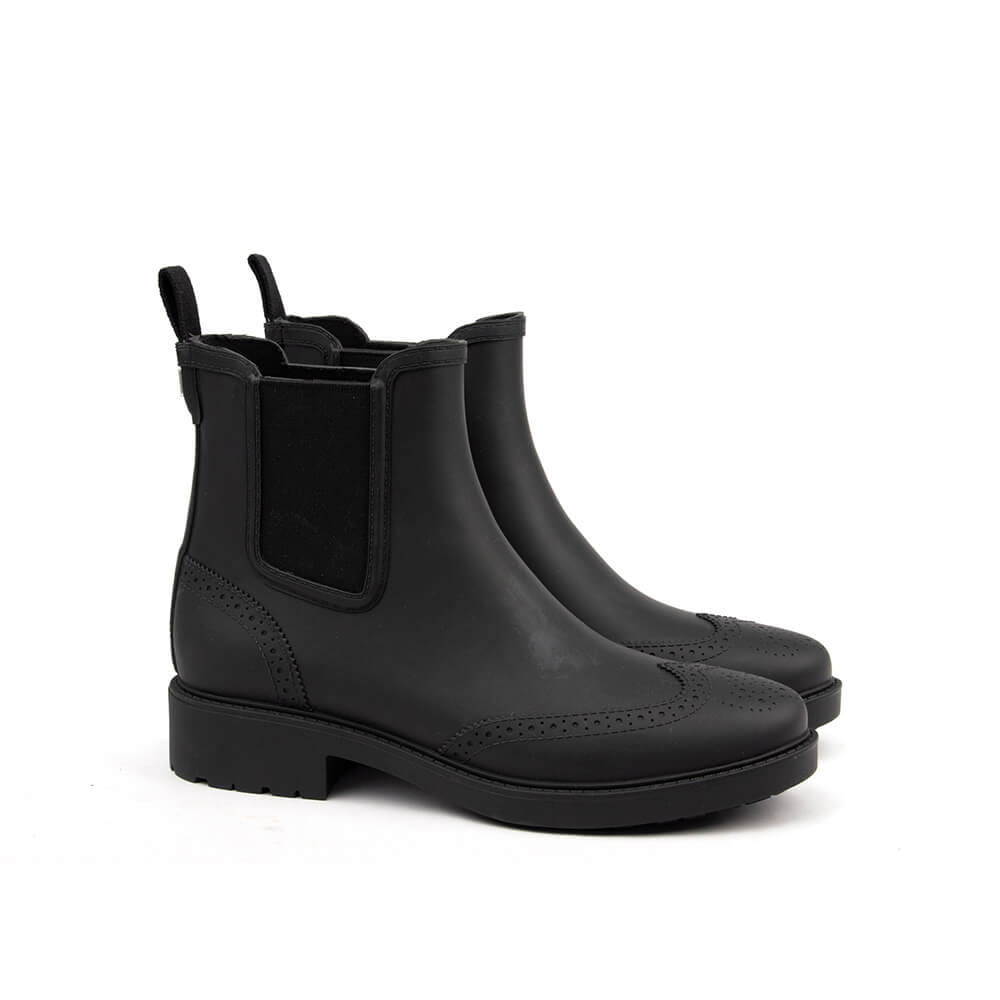 Black rubber Chelsea boots brogue wingtip perforations matte finish women