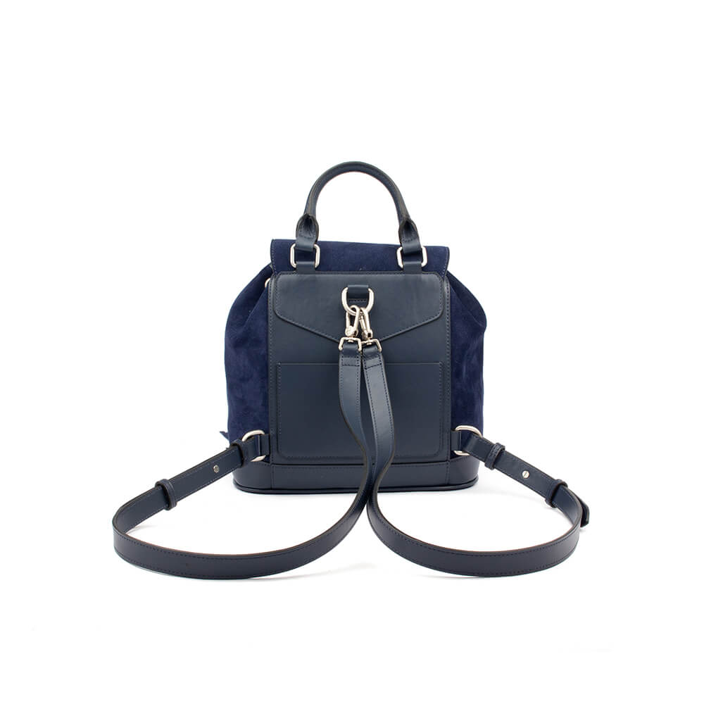Designer-style fringe flap backpack with signature logo emblem in navy