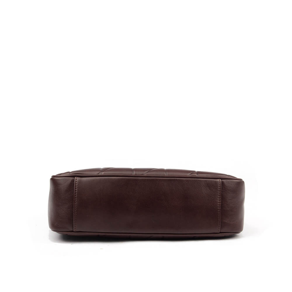 Elegant quilted leather shoulder bag with gold chain drape and tassel zip pulls