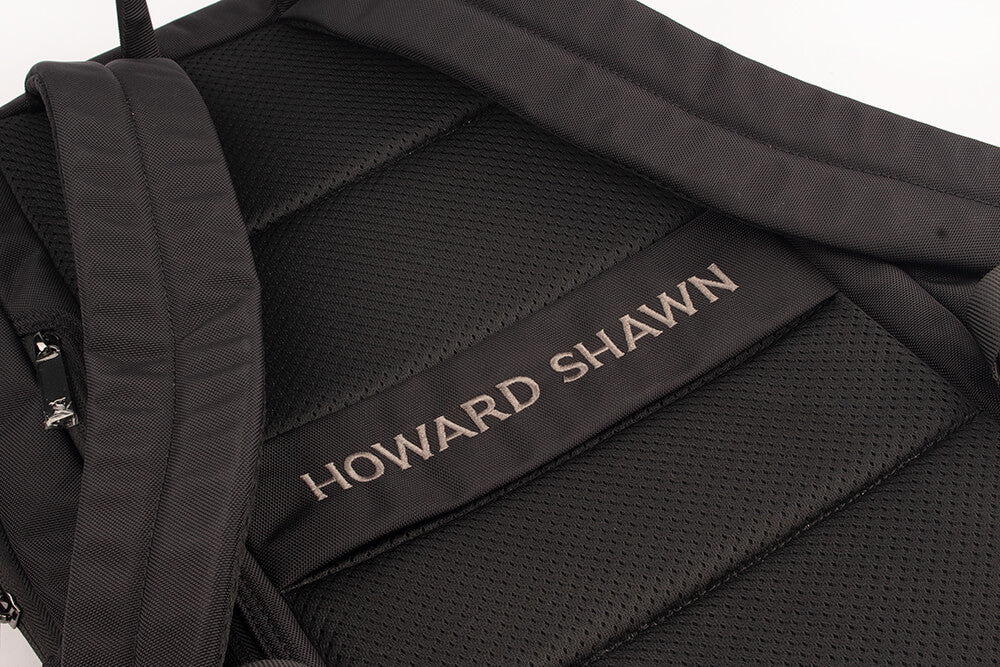 Black nylon backpack with large embroidered Howard Shawn logo and silver zip hardware