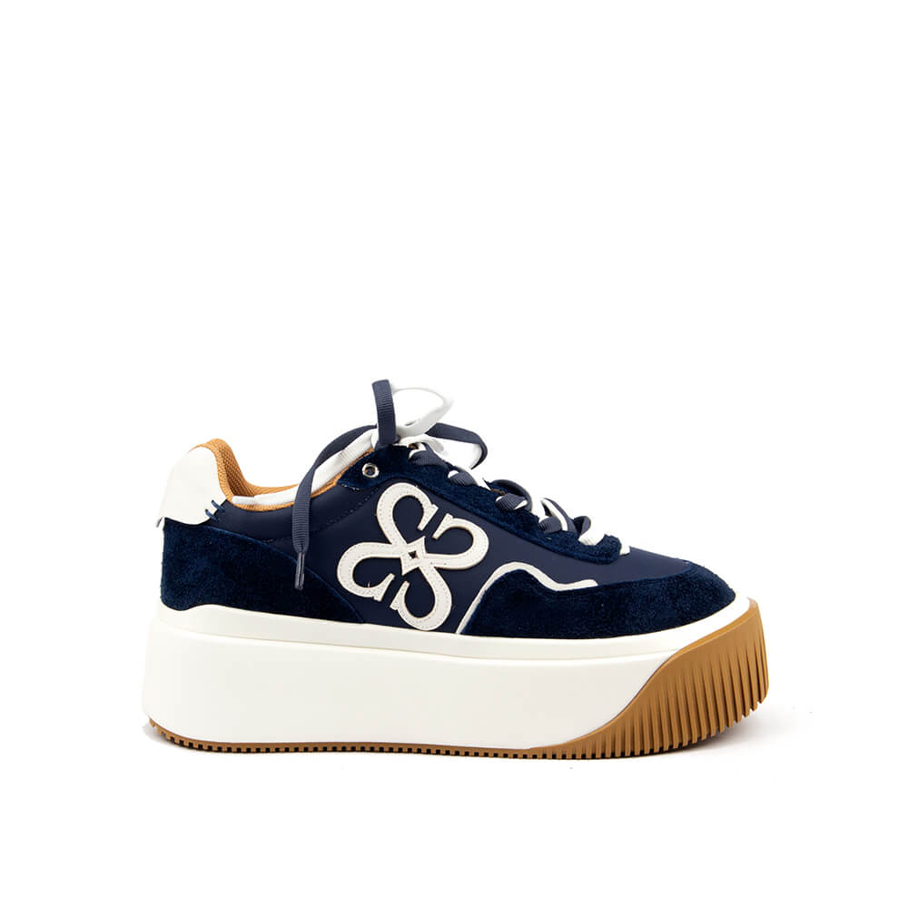 Women's platform sneakers in midnight navy with white logo emblem and gum sole