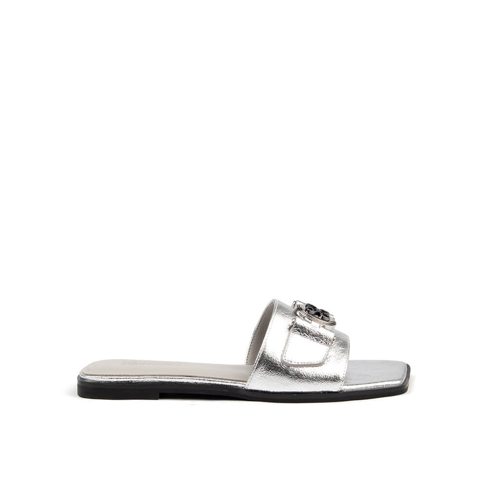 Silver metallic flat slide sandal with logo medallion and square toe top view