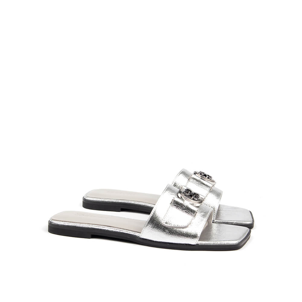 Women's silver metallic flat slide sandal logo medallion square toe overhead view