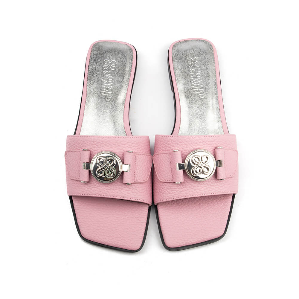 Pebbled blush pink leather flat mule with silver circular logo and grey insole