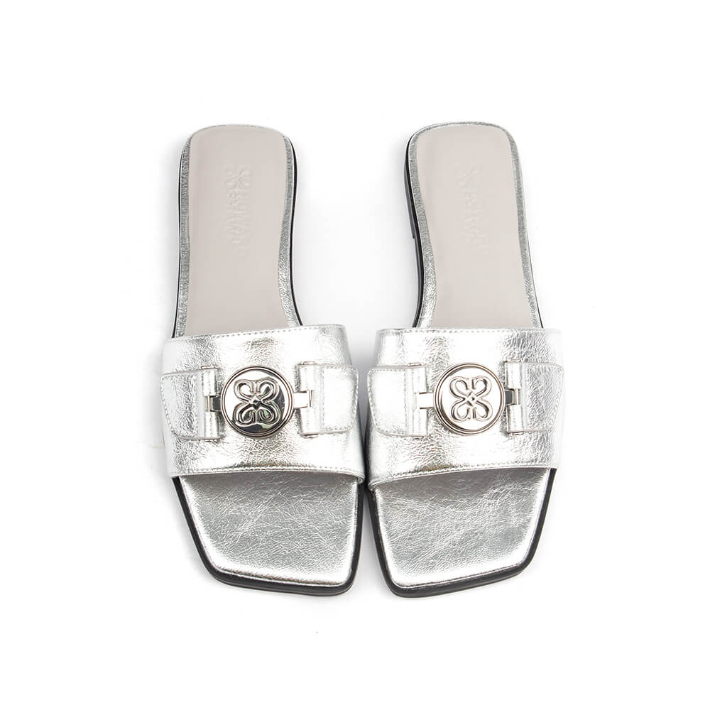 Chic silver metallic flat mule sandal with logo for summer or evening wear