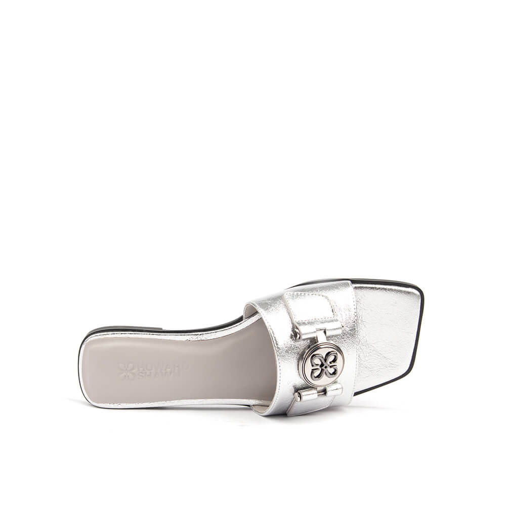 Crinkle silver foil leather flat slide with circular logo medallion top view
