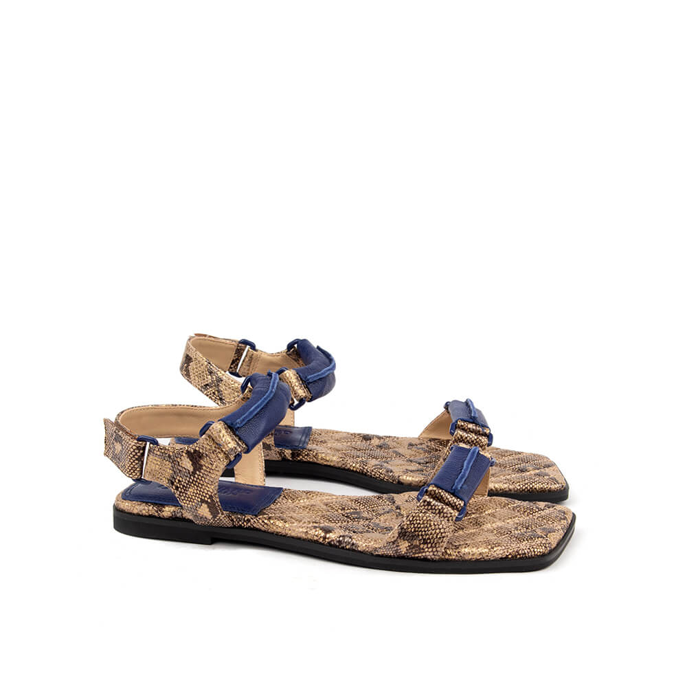 Women's flat summer sandals with brown snake print and blue ankle strap