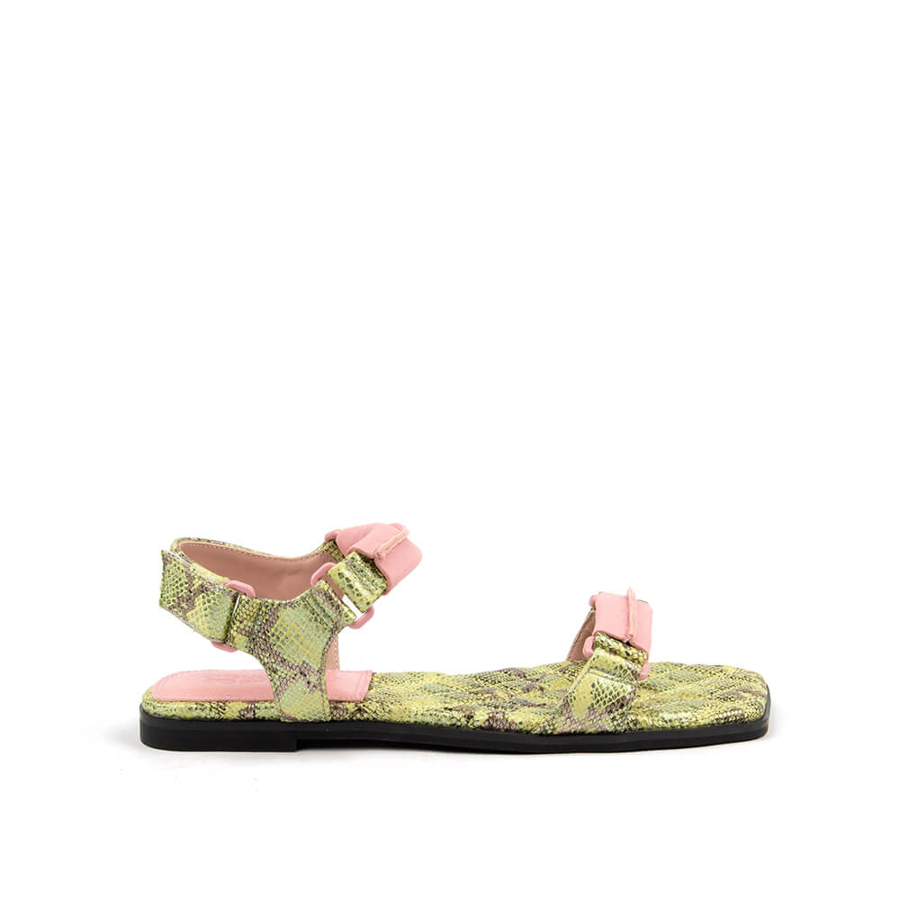 Snake embossed flat sandals in lime green python print with pink buckle strap