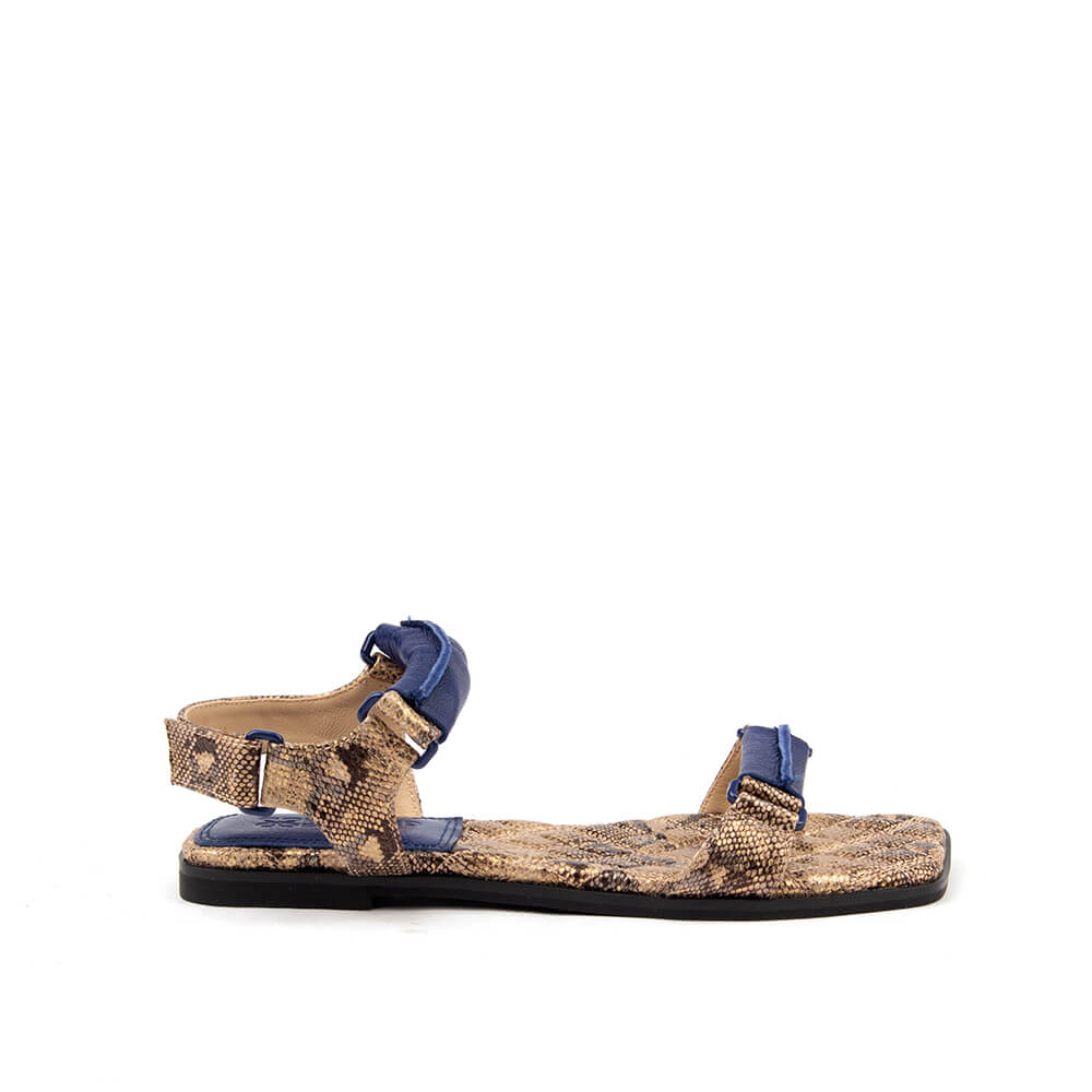 Snake embossed flat sandals in desert brown python print with navy buckle strap