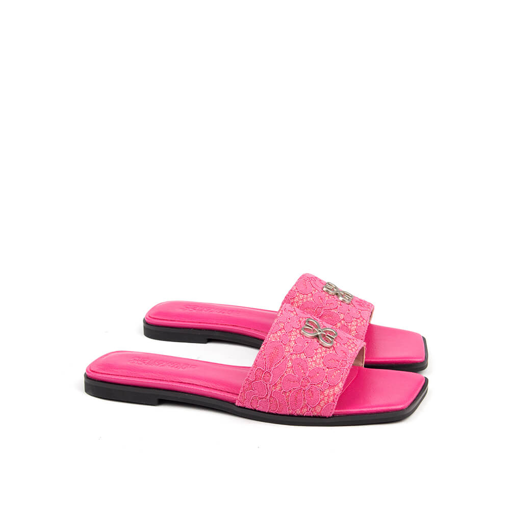 Fuchsia lace flat slides with wide lace band and silver logo detail — pair view
