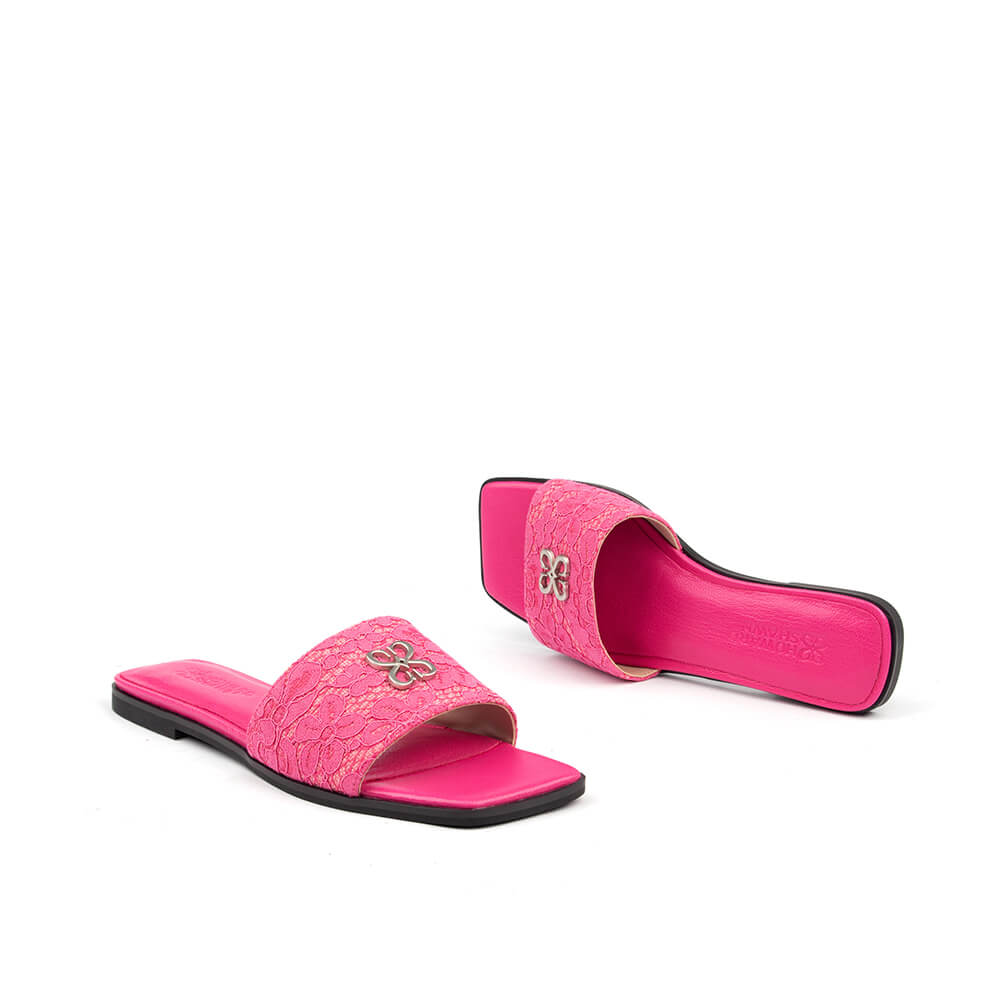 Floral lace slide sandals with silver brand logo — front angled view