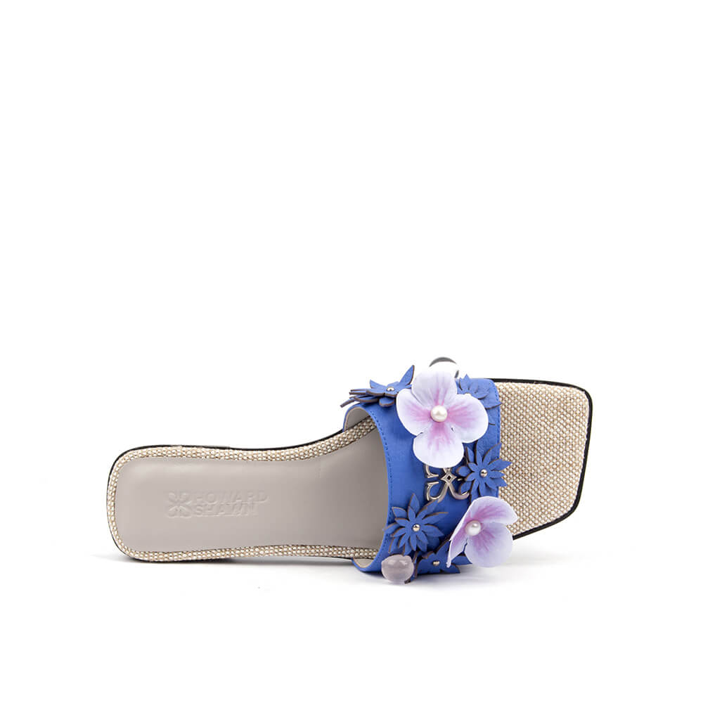 Blue leather flat slide with floral appliqué strap and sparkling crystal footbed