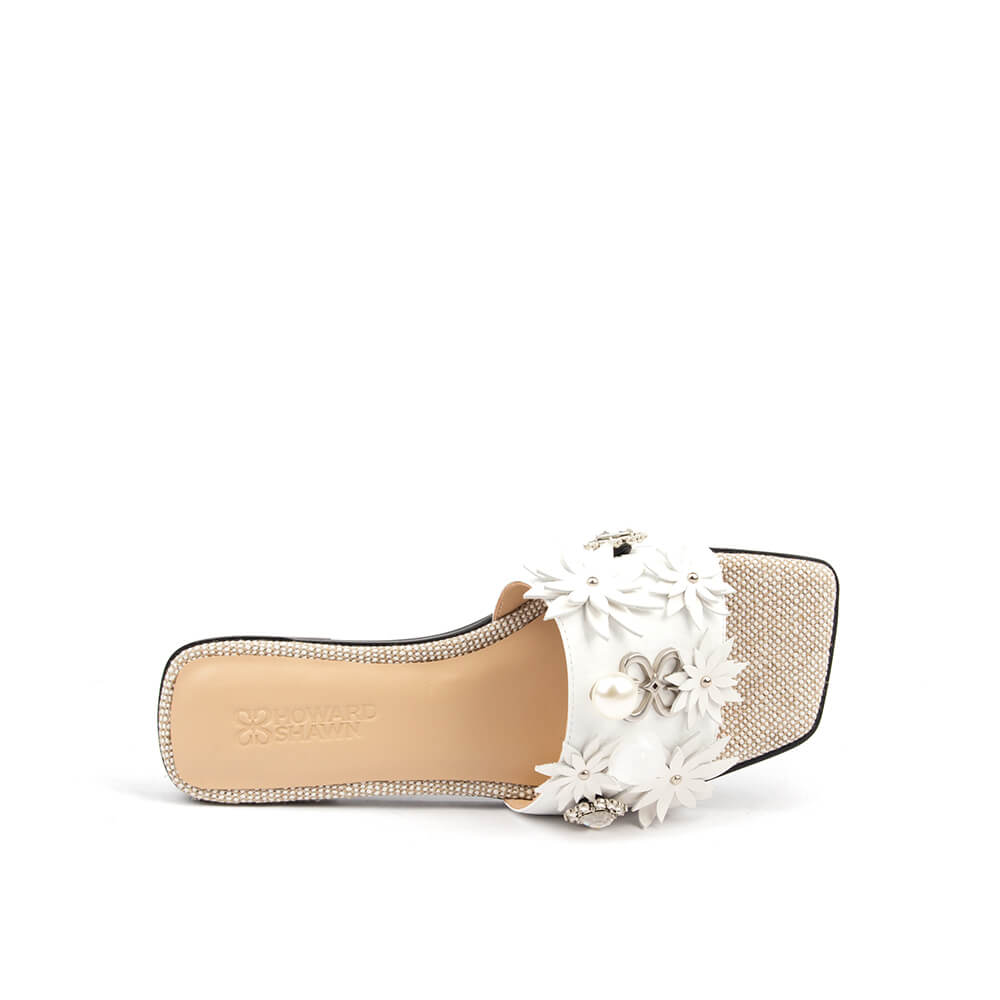 White leather flat slide with floral appliqué strap and sparkling rhinestone footbed
