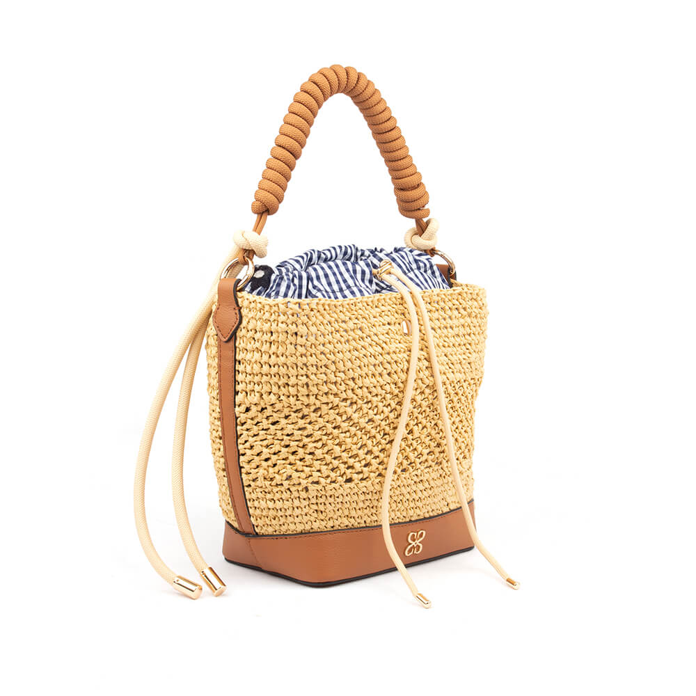 Natural straw bucket bag with drawstring gingham interior and gold hardware