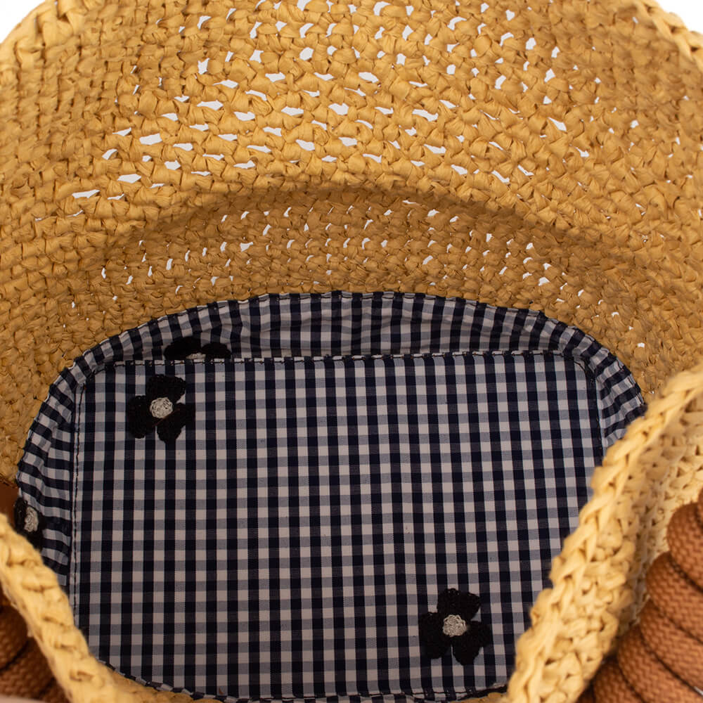 Women's summer handbag in woven straw with tan leather base detail