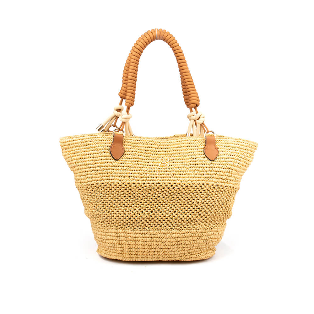 Woven straw tote bag with coiled rope handles and leather tab detail in natural beige