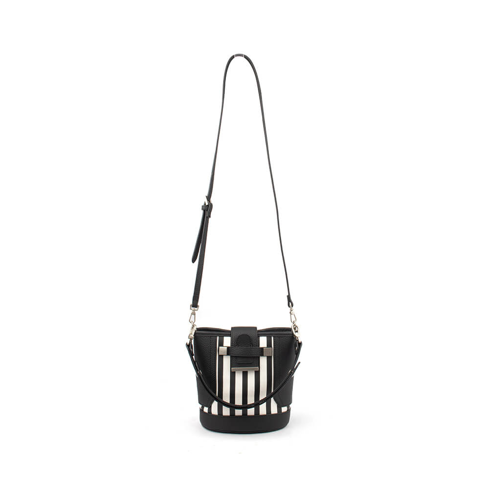 Striped leather bucket bag in black and white with tab closure and silver hardware