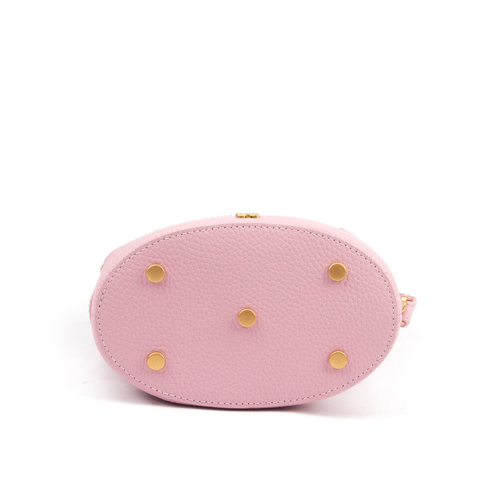 Soft pink leather bucket bag with white stripe panel and brand logo at base