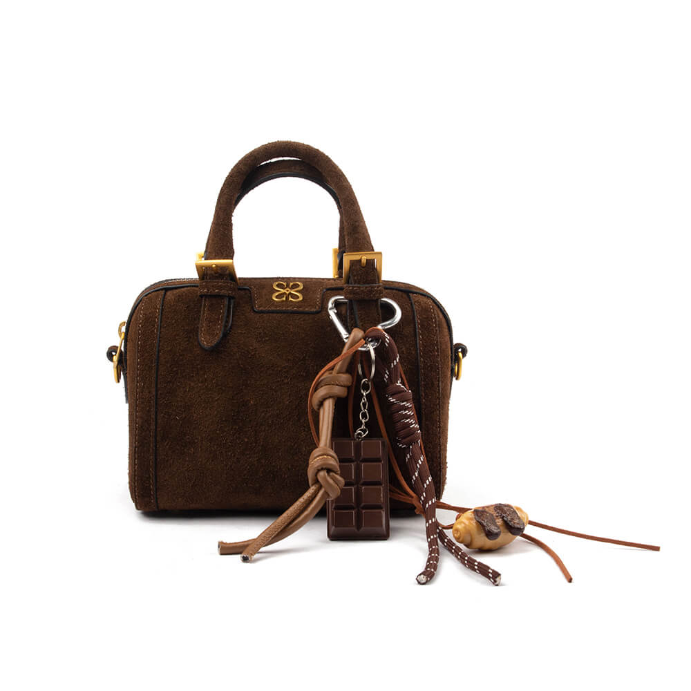 Brown suede mini boston bag with gold hardware and novelty charm accessories