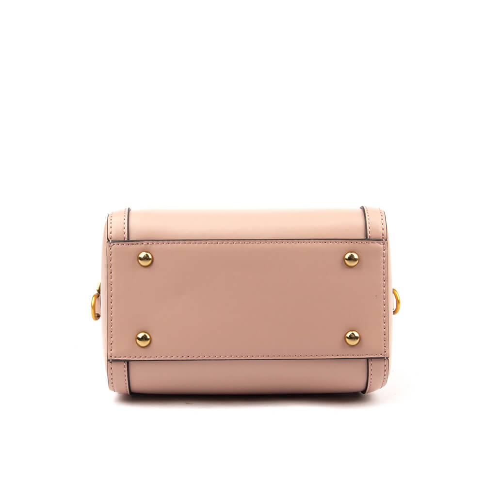 Smooth blush leather mini bag with zip closure gold buckle and logo emblem