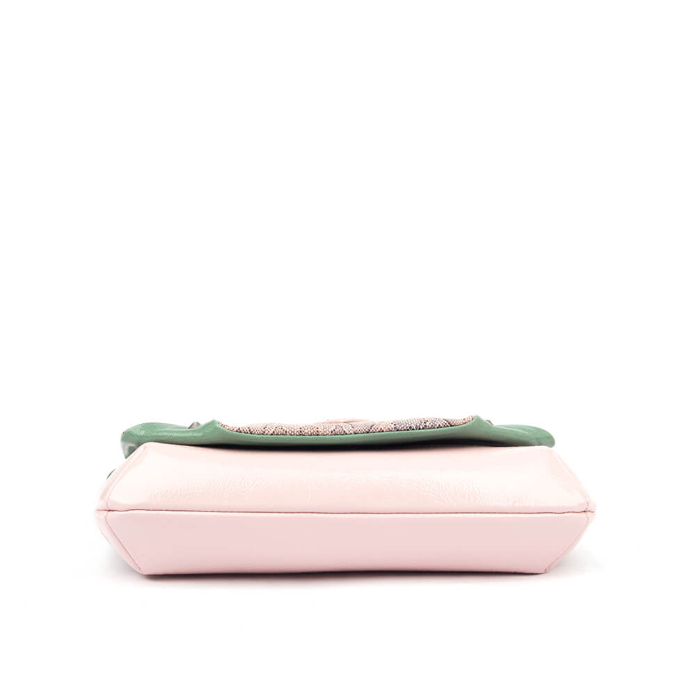 Women's snake embossed crossbody bag with front zip and logo emblem in pink