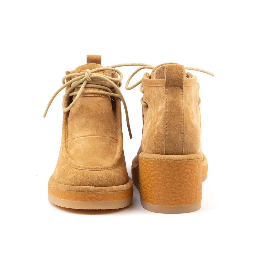 Women's tan suede chukka wedge boots white background