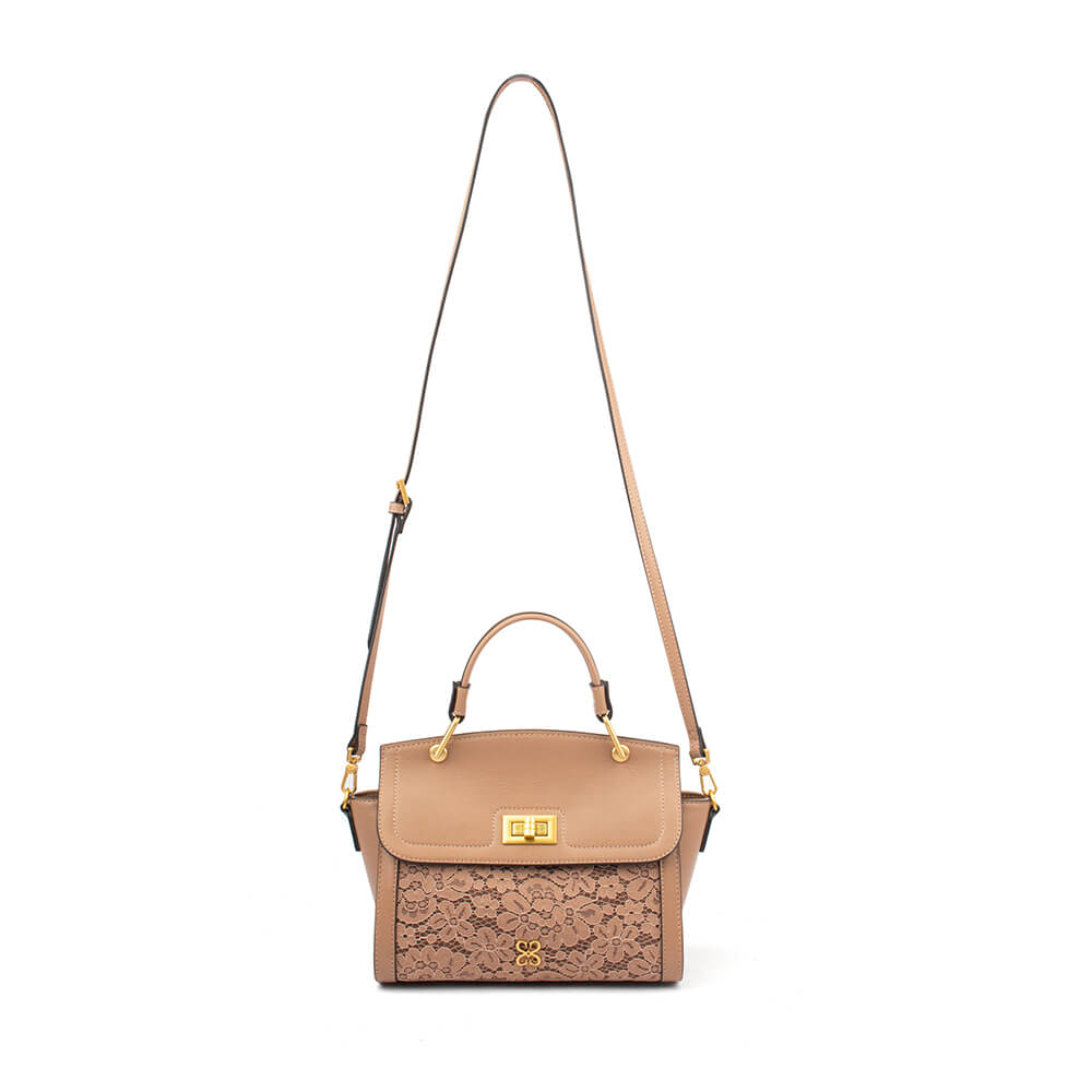 Leather flap bag with floral lace overlay pocket and D-ring handle connectors