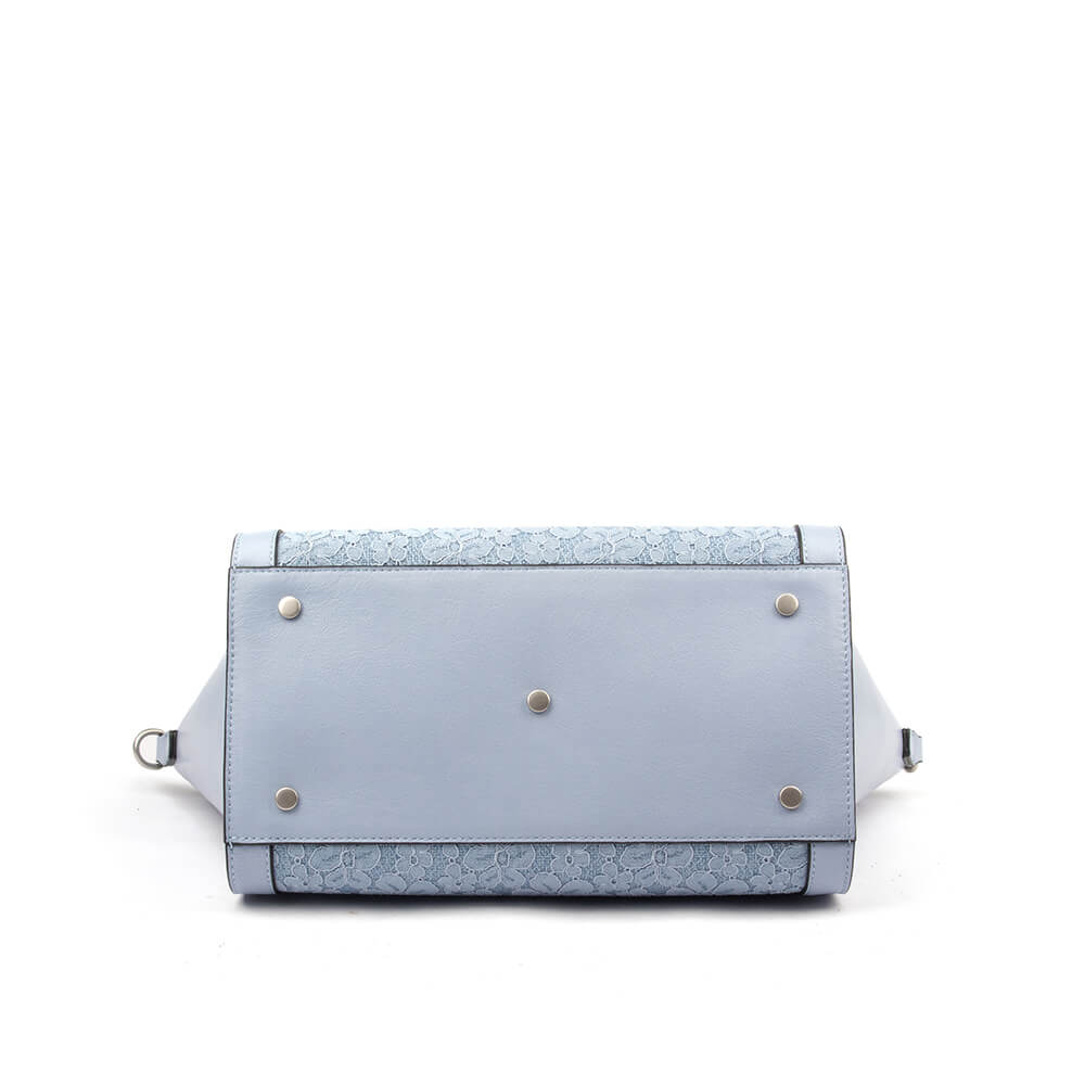 Light blue pebbled leather tote with lace pocket and adjustable crossbody strap