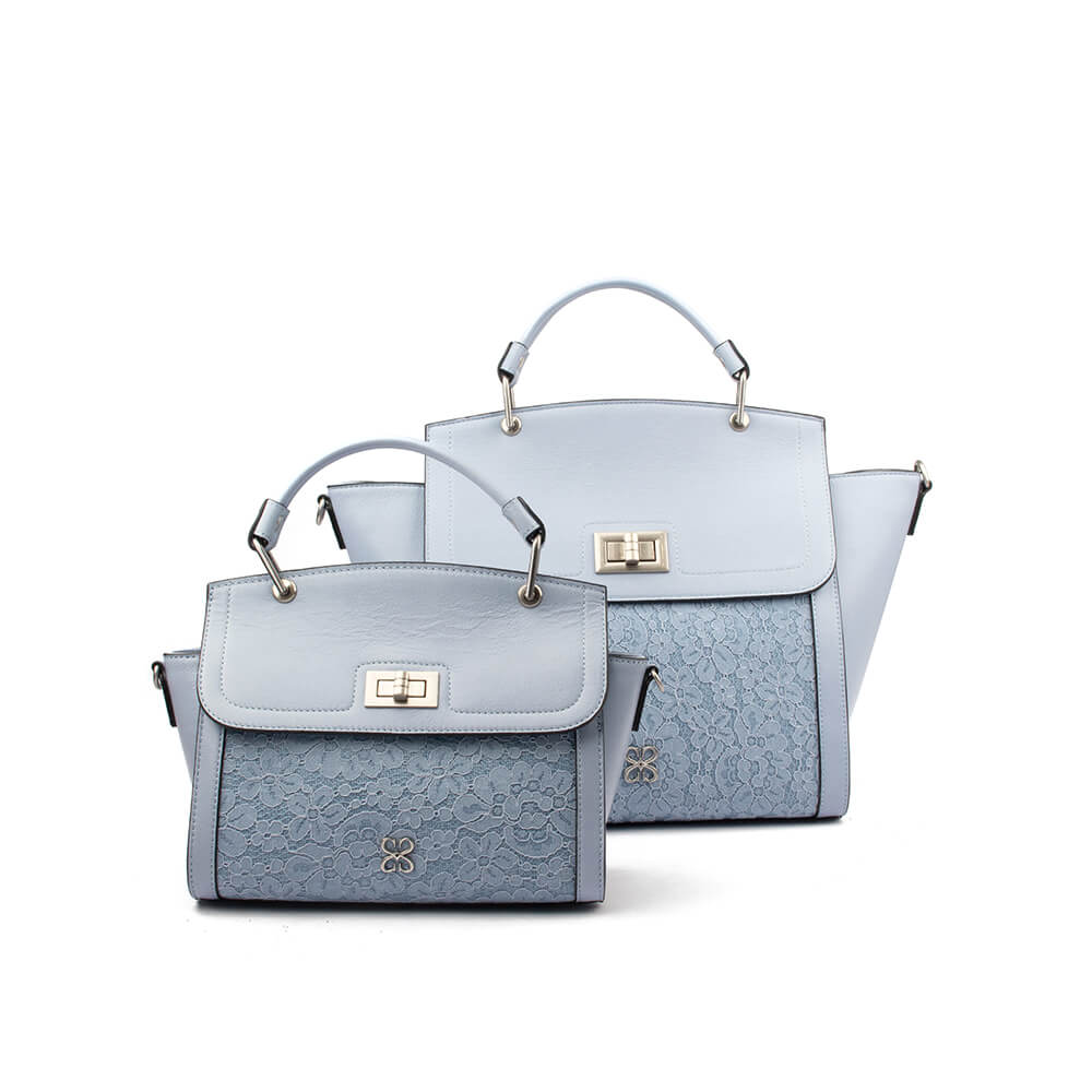 Powder blue leather winged bag with floral lace overlay — front view