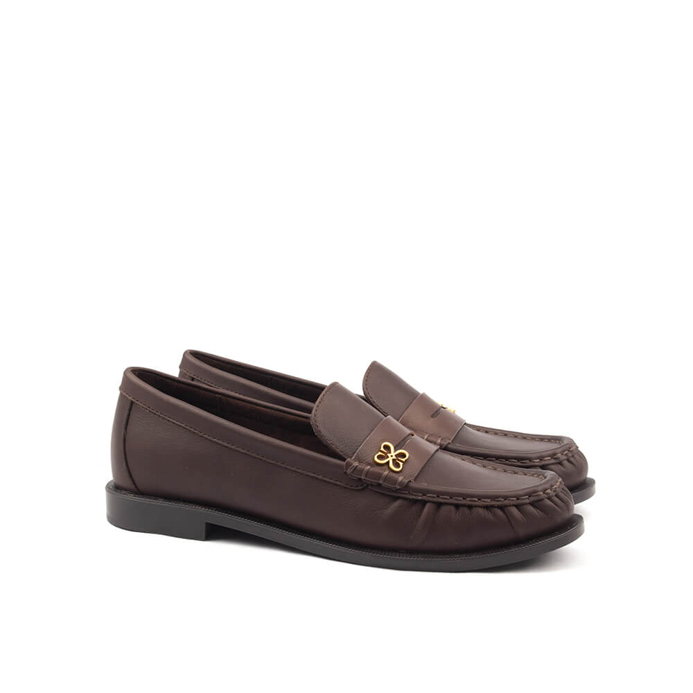 Rich brown leather slip-on loafers with gold four-petal emblem women