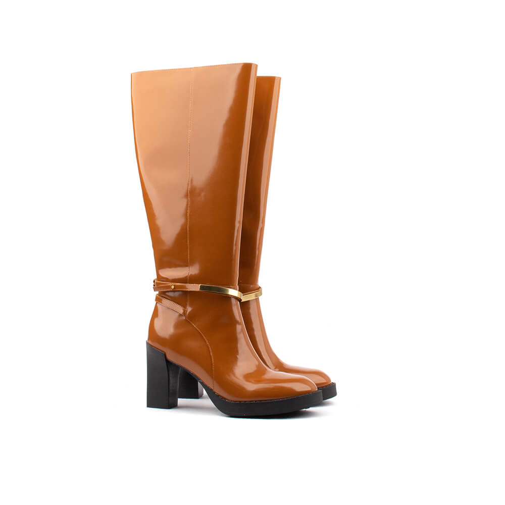 Women's cognac patent leather knee-high boots with gold bar ankle strap and block heel